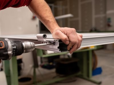 male-with-red-shirt-making-window-with-industrial-tools_181624-50175
