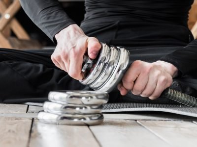 man-setting-up-discs-dumbbell_23-2148241639